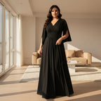A woman wearing a floor-length black gown with a V-neckline, 