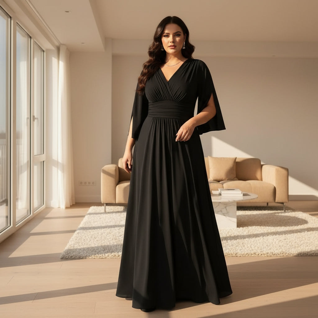 A woman wearing a floor-length black gown with a V-neckline, 