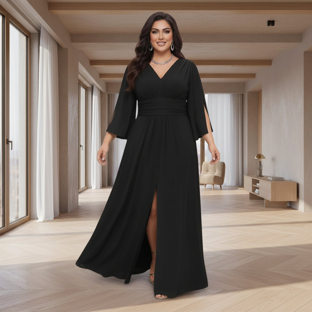 A woman modeling a long black maxi dress with a V-neckline, elbow-length sleeves, side slit details,